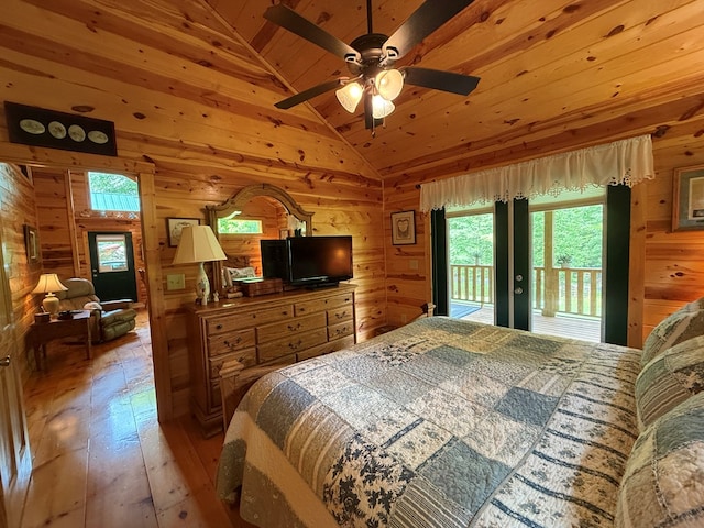 100 Bryant Farm Rd, Murphy, NC 28906 - bedroom featuring wooden walls, vaulted ceiling, multiple windows, access to outside, and light wood-type flooring