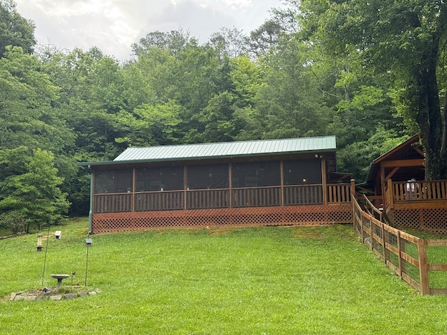 100 Bryant Farm Rd, Murphy, NC 28906 - view of front of home with a sunroom, a front yard, a deck, and a metal roof