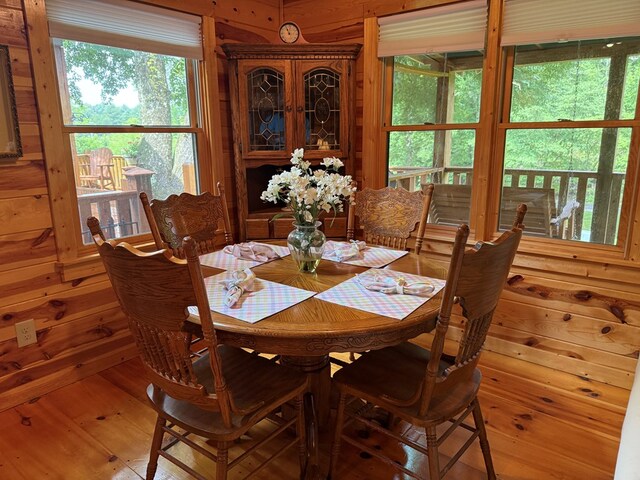 100 Bryant Farm Rd, Murphy, NC 28906 - dining area featuring hardwood / wood-style flooring, healthy amount of natural light, and wooden walls