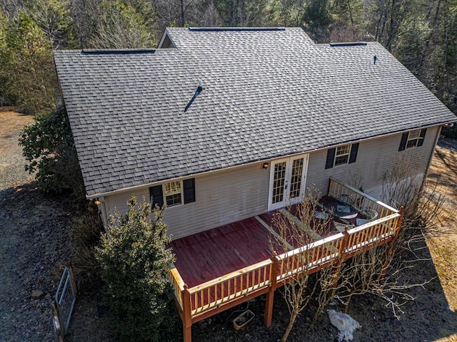 back of property featuring a wooden deck and french doors