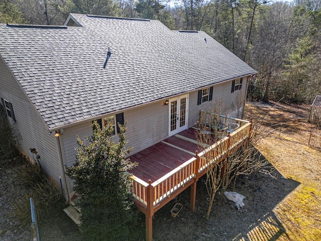 back of property featuring a wooden deck and french doors