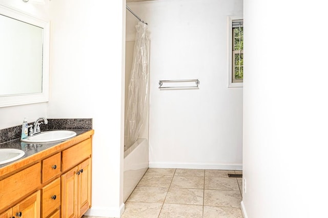 bathroom featuring shower / tub combo with curtain, vanity, and tile patterned flooring