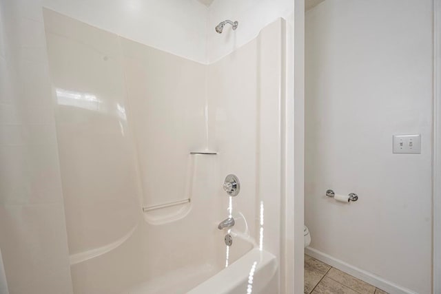 bathroom featuring  shower combination, toilet, and tile patterned flooring