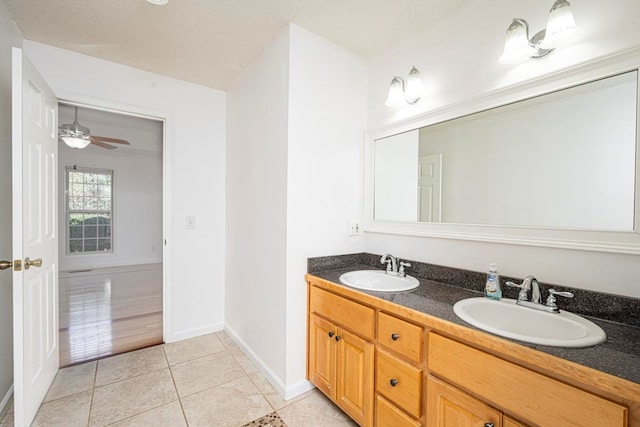 bathroom featuring vanity, ceiling fan, tile patterned floors, and a textured ceiling