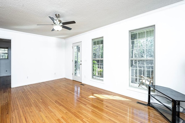 unfurnished room with crown molding, ceiling fan, hardwood / wood-style flooring, and a textured ceiling