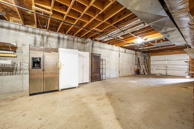 garage with white fridge and stainless steel fridge