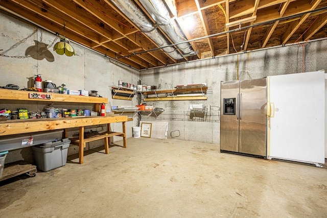 basement with stainless steel fridge with ice dispenser