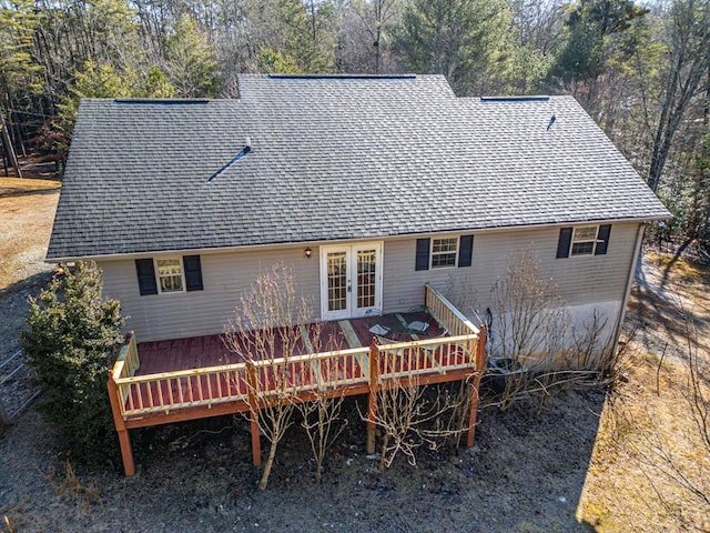 back of property featuring a wooden deck and french doors