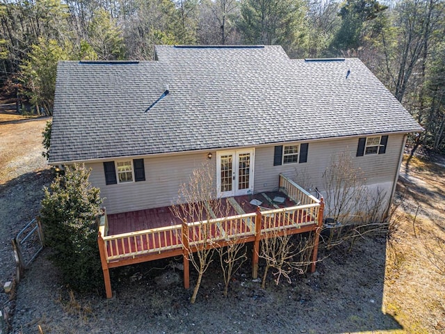 back of house featuring a wooden deck and french doors