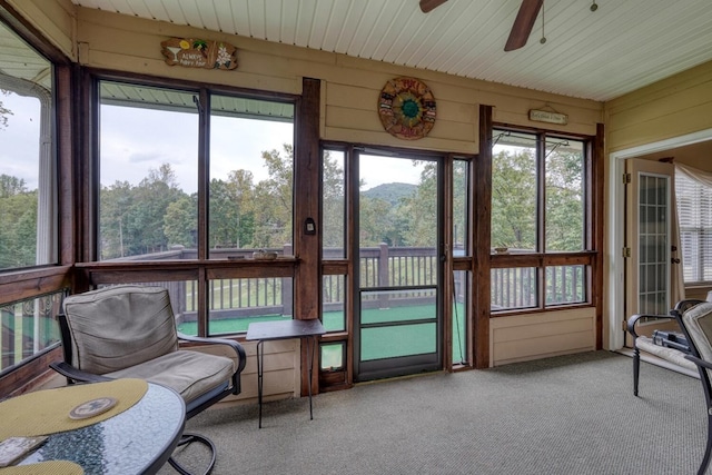 sunroom featuring ceiling fan