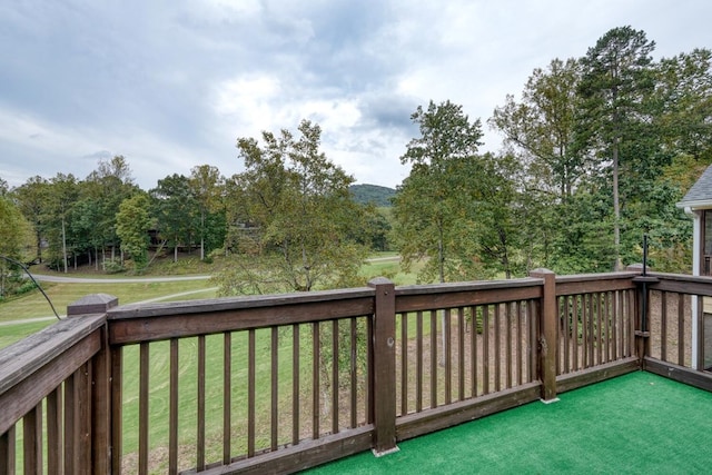 wooden terrace with a lawn