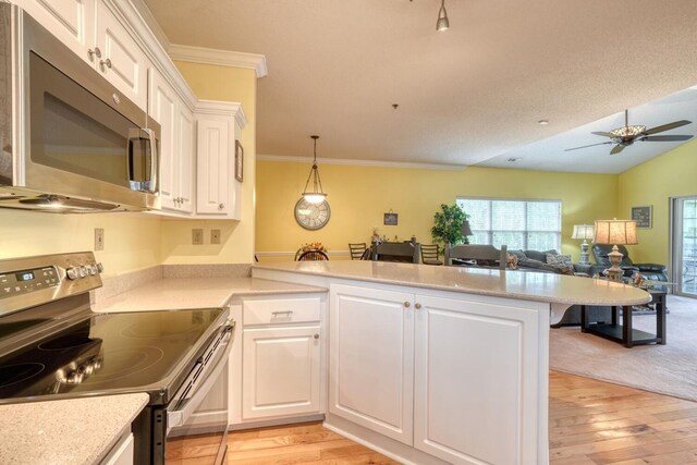 kitchen with light wood-type flooring, stainless steel appliances, and white cabinets