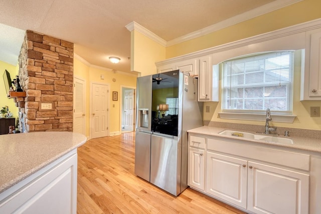 kitchen featuring light hardwood / wood-style floors, a textured ceiling, stainless steel fridge with ice dispenser, sink, and white cabinets