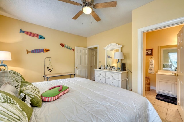 tiled bedroom with a textured ceiling and ceiling fan