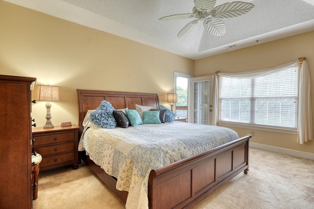 carpeted bedroom featuring a textured ceiling and ceiling fan