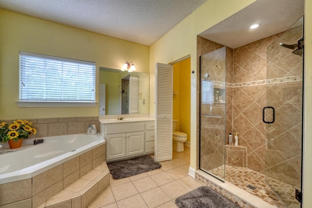 full bathroom with vanity, toilet, independent shower and bath, a textured ceiling, and tile patterned flooring