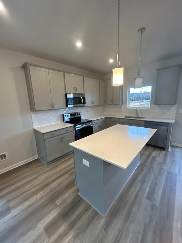 kitchen featuring gray cabinets, appliances with stainless steel finishes, and a center island