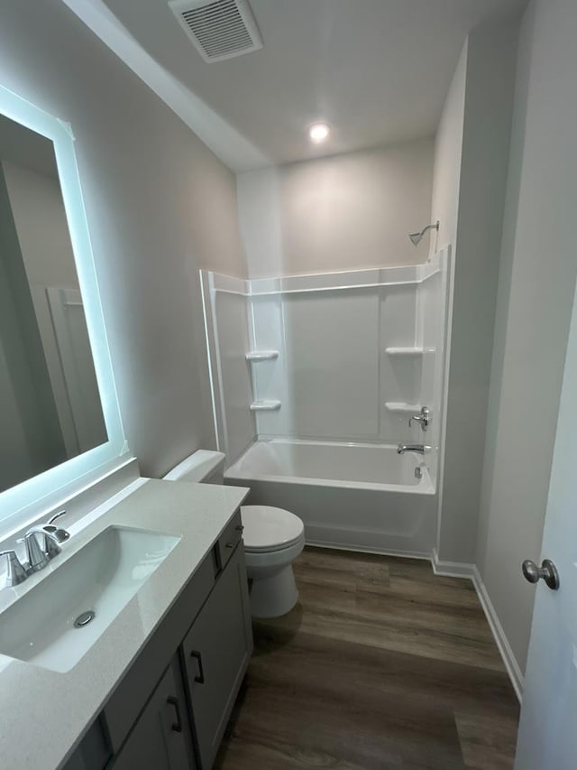 full bathroom featuring vanity, toilet, tub / shower combination, and hardwood / wood-style floors