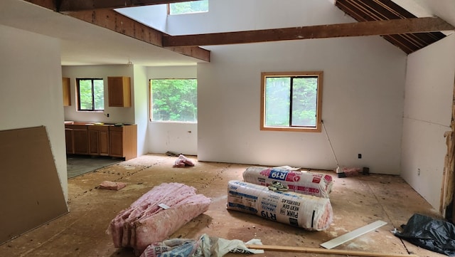 living room featuring vaulted ceiling with skylight and a healthy amount of sunlight