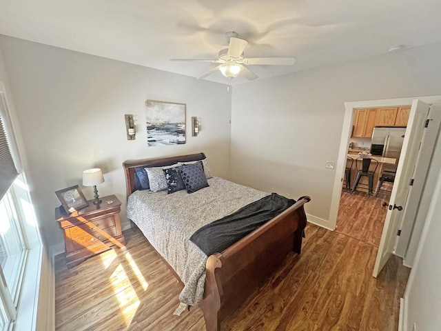 36 Rustic Barn Trl, Morganton, GA 30560 - bedroom with stainless steel refrigerator with ice dispenser, wood finished floors, and a ceiling fan