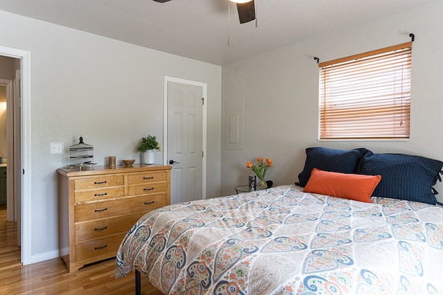 bedroom with ceiling fan, baseboards, and light wood-style floors