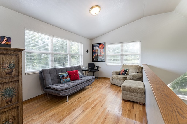 living area with light wood finished floors and vaulted ceiling