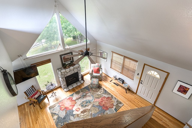 living room featuring plenty of natural light, ceiling fan, and wood finished floors