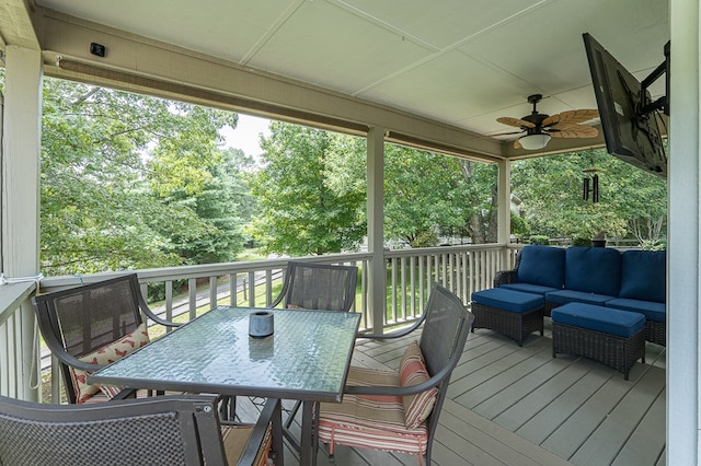 wooden deck with an outdoor living space, outdoor dining area, and ceiling fan