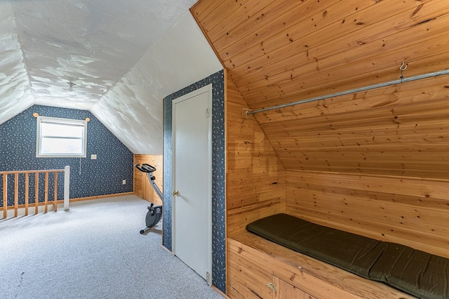 interior space with carpet floors and vaulted ceiling