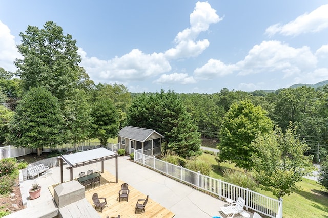 exterior space with an outbuilding, outdoor dining area, and fence