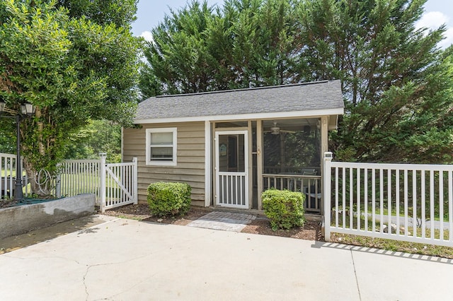 view of outbuilding featuring an outdoor structure and fence