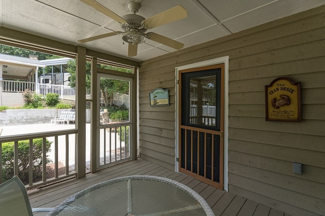 wooden deck with a ceiling fan and fence