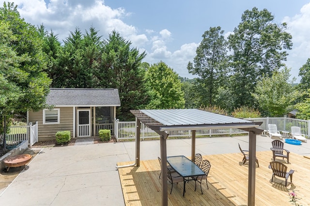 view of patio / terrace featuring an outdoor structure, outdoor dining area, and fence