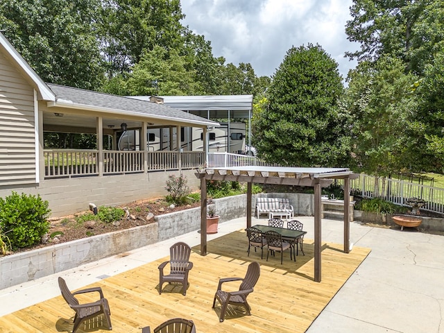 deck featuring outdoor dining area and fence