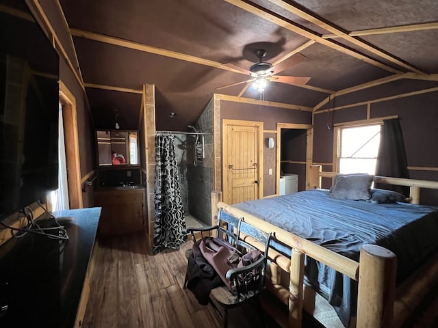 bedroom with hardwood / wood-style flooring, ceiling fan, and vaulted ceiling