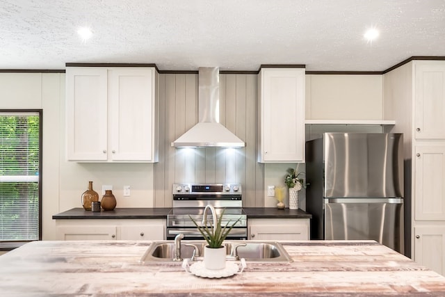 251 Ebenezer Rd, Ellijay, GA 30536 - kitchen with white cabinetry, wall chimney exhaust hood, a textured ceiling, and appliances with stainless steel finishes