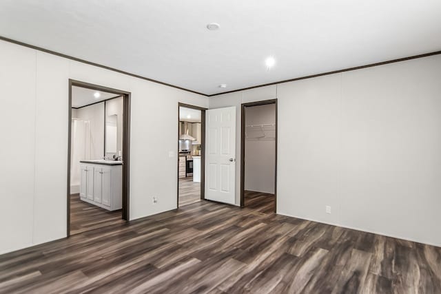 251 Ebenezer Rd, Ellijay, GA 30536 - unfurnished bedroom with ensuite bath, a closet, crown molding, and dark wood-type flooring