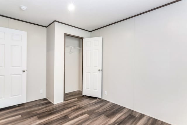 251 Ebenezer Rd, Ellijay, GA 30536 - unfurnished bedroom with crown molding, a closet, and dark wood-style flooring