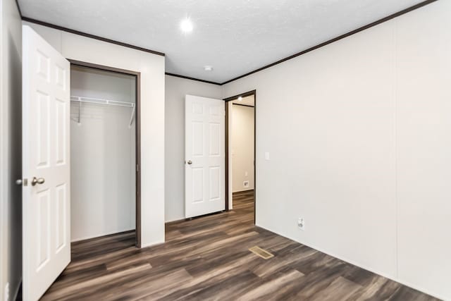 251 Ebenezer Rd, Ellijay, GA 30536 - unfurnished bedroom featuring a closet, dark wood finished floors, a textured ceiling, and crown molding