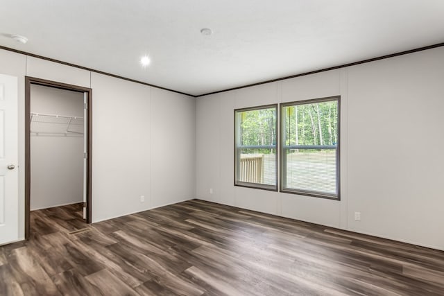251 Ebenezer Rd, Ellijay, GA 30536 - unfurnished bedroom featuring a closet, dark wood-style flooring, a walk in closet, and crown molding
