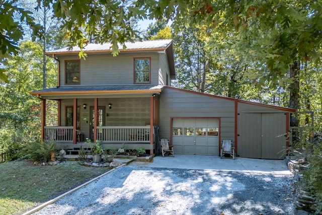 front facade featuring covered porch and a garage