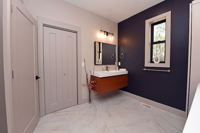 bathroom featuring visible vents, marble finish floor, vanity, and baseboards