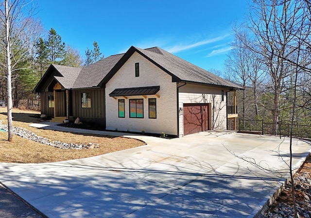 view of side of home with a garage, driveway, and board and batten siding