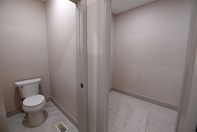 bathroom featuring toilet, baseboards, and visible vents