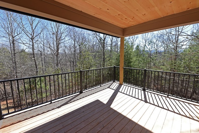 wooden deck with a view of trees