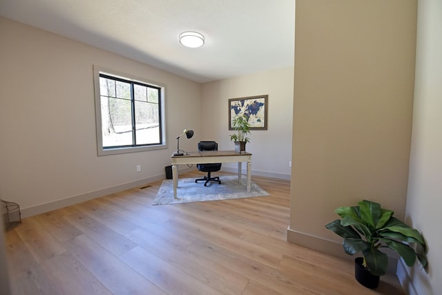 home office featuring light wood-type flooring and baseboards