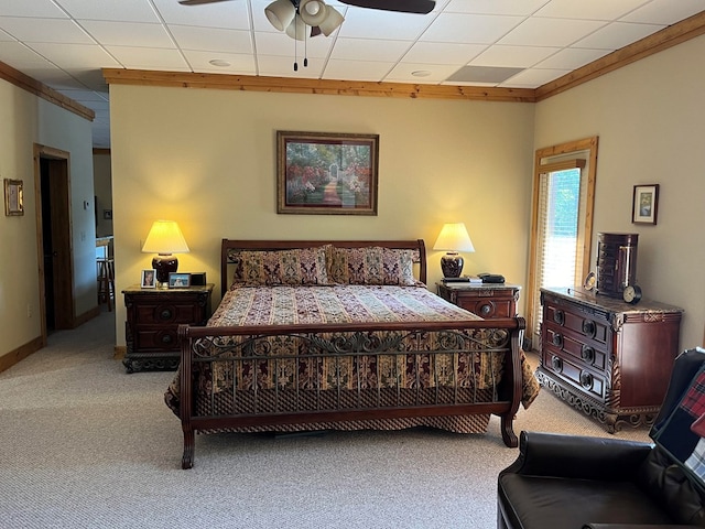 carpeted bedroom with crown molding, a paneled ceiling, and ceiling fan