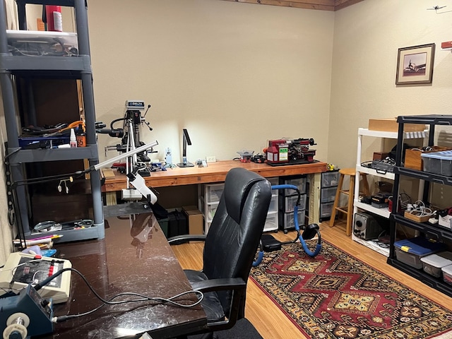 office area with hardwood / wood-style flooring and a workshop area