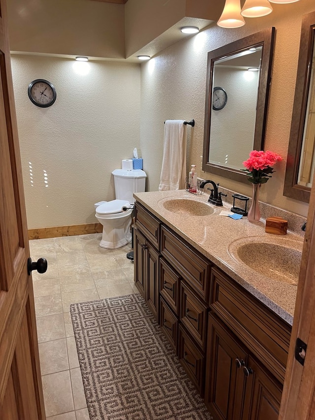 bathroom featuring vanity, toilet, and tile patterned floors