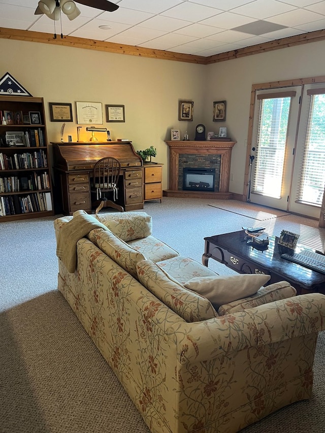 carpeted living room featuring crown molding and ceiling fan